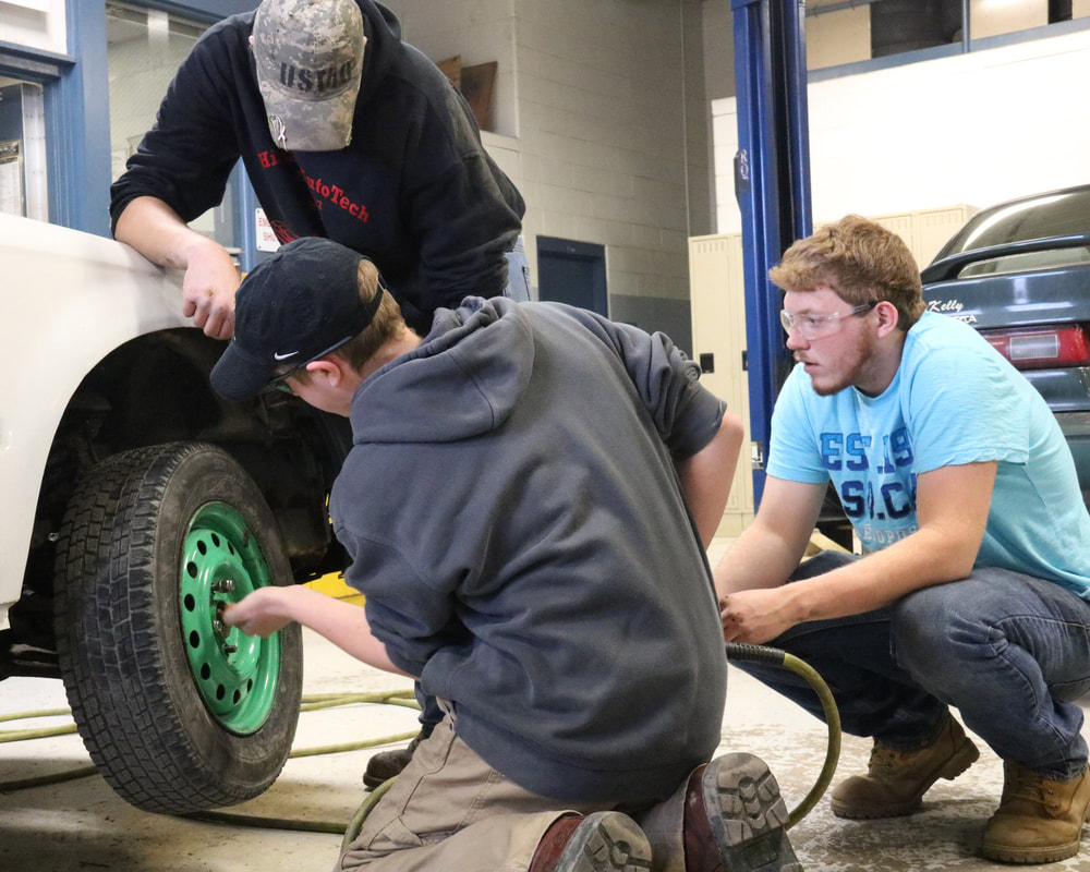 students fixing tire Picture