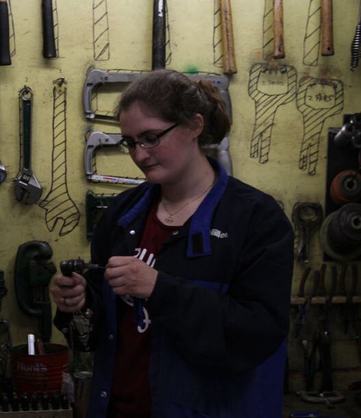 female student picking out tools Picture